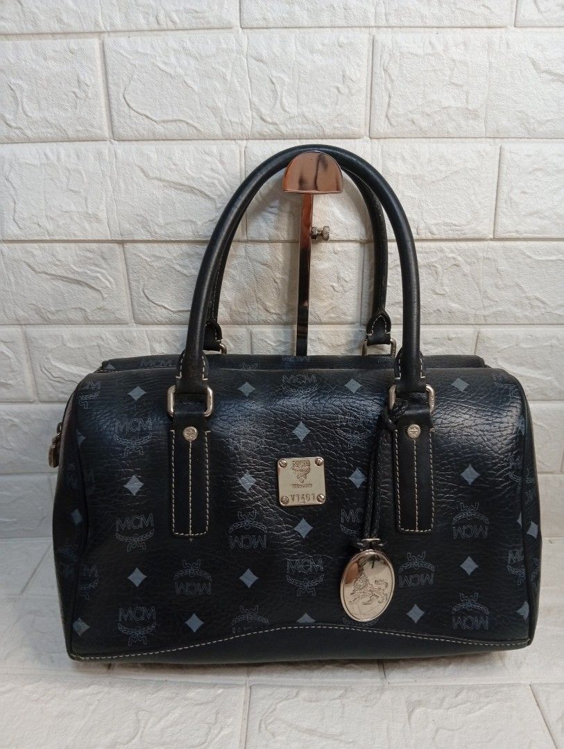 MCM Monogram Boston Bag Black Leather (Category: Shoulder Bags) located in Las Pinas. Submitted by etoksi1234 (Listing ID 1462181153, Image 1). Description: Pre-loved MCM Black Visetos Boston Bag featuring the brand's signature monogram coated canvas and a hanging metallic logo charm. Silver tone hardware..