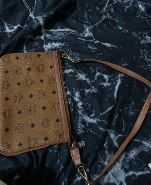 MCM Monogram Clutch Bag (Category: Luxury Bags & Wallets) located in Cavite. Submitted by live.staypretty_012 (Listing ID 1462254233, Image 3). Description: - Authentic MCM monogram clutch - Features leather trim and strap - Interior with patterned lining - gold hardware - Ideal for carrying your daily essentials FYI : needs zipper rework.