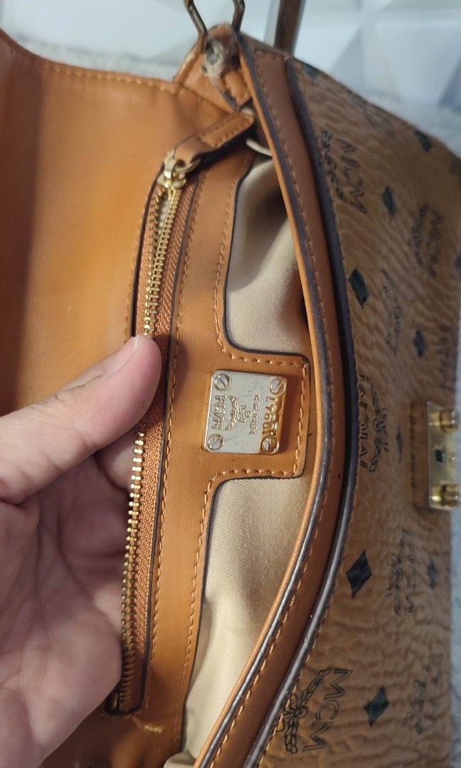 MCM Monogrammed Leather Chain Shoulder Bag (Category: Luxury Bags & Wallets) located in Pasig City. Submitted by xcess_baggage (Listing ID 1461822802, Image 2). Description: - Authentic MCM monogrammed leather shoulder bag - Classic design with gold-tone hardware - Signature MCM clasp - Detachable chain strap - Interior zipper pocket - Note: Some wear on the strap attachment point.