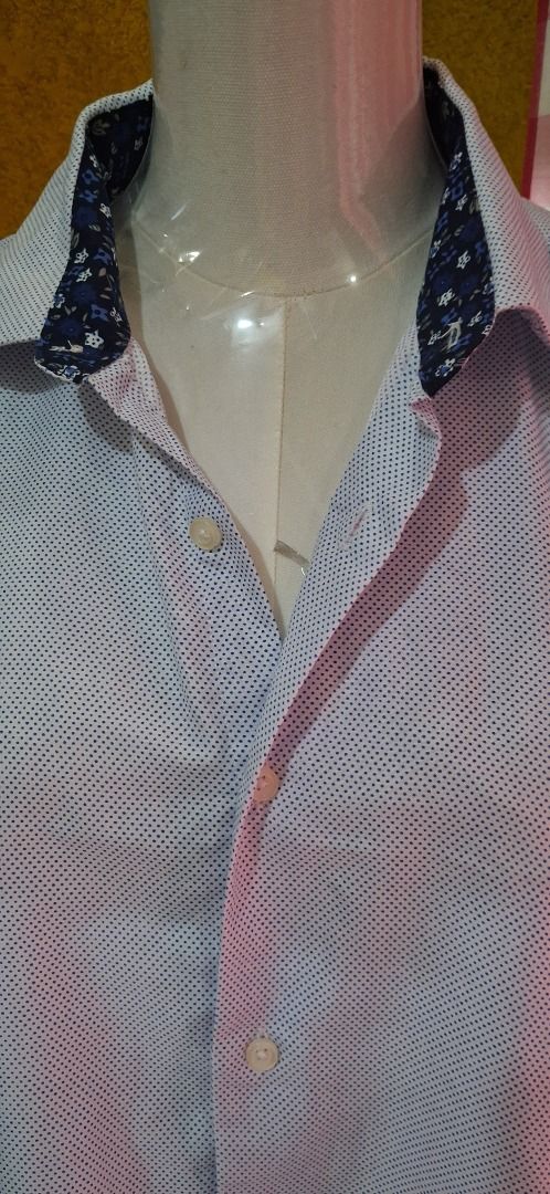 Men's Long Sleeve Button Up Shirt (Category: Tshirts & Polo Shirts ) located in Manila. Submitted by katkween23 (Listing ID 1462058487, Image 3). Description: - Light blue shirt with subtle dark blue dot pattern - Contrasting floral print on the collar - Button-up front - Long sleeves - Comfortable fit for casual or smart-casual wear - Ideal for everyday use.