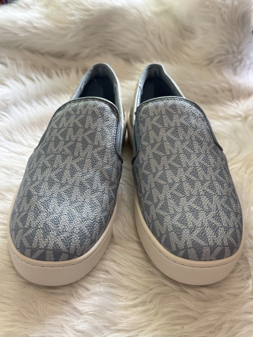 Michael Kors MK Logo Slip-On Sneakers (Category: Sneakers) located in Manila. Submitted by sariestore (Listing ID 1462065388, Image 1). Description: - RFS: Decluttering -Authentic Michael Kors slip-on sneakers - Classic all-over MK logo pattern - Stylish light blue and beige colorway - Easy slip-on design -Size:6 - Subtle metal MK logo detail on the back - Ideal for casual outings and everyday wear No box included, never been used (Minor leather 