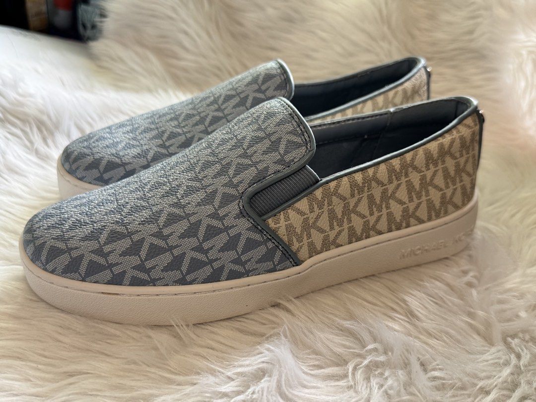 Michael Kors MK Logo Slip-On Sneakers (Category: Sneakers) located in Manila. Submitted by sariestore (Listing ID 1462065388, Image 3). Description: - RFS: Decluttering -Authentic Michael Kors slip-on sneakers - Classic all-over MK logo pattern - Stylish light blue and beige colorway - Easy slip-on design -Size:6 - Subtle metal MK logo detail on the back - Ideal for casual outings and everyday wear No box included, never been used (Minor leather 