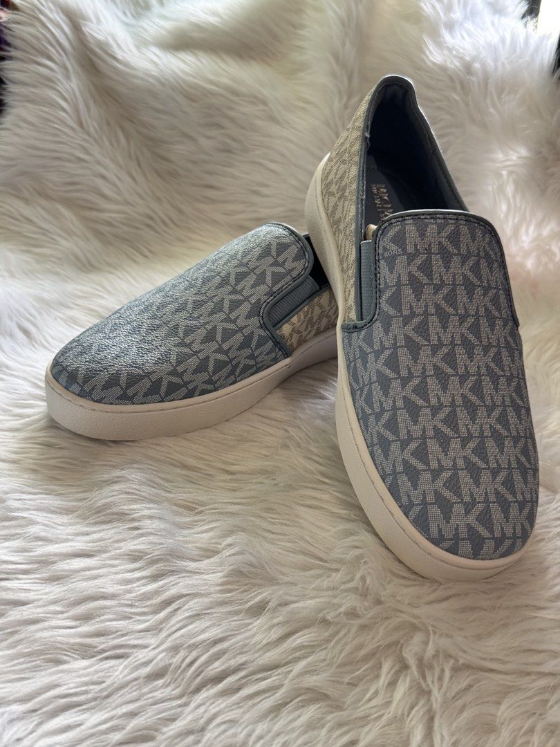 Michael Kors MK Logo Slip-On Sneakers (Category: Sneakers) located in Manila. Submitted by sariestore (Listing ID 1462065388, Image 2). Description: - RFS: Decluttering -Authentic Michael Kors slip-on sneakers - Classic all-over MK logo pattern - Stylish light blue and beige colorway - Easy slip-on design -Size:6 - Subtle metal MK logo detail on the back - Ideal for casual outings and everyday wear No box included, never been used (Minor leather 
