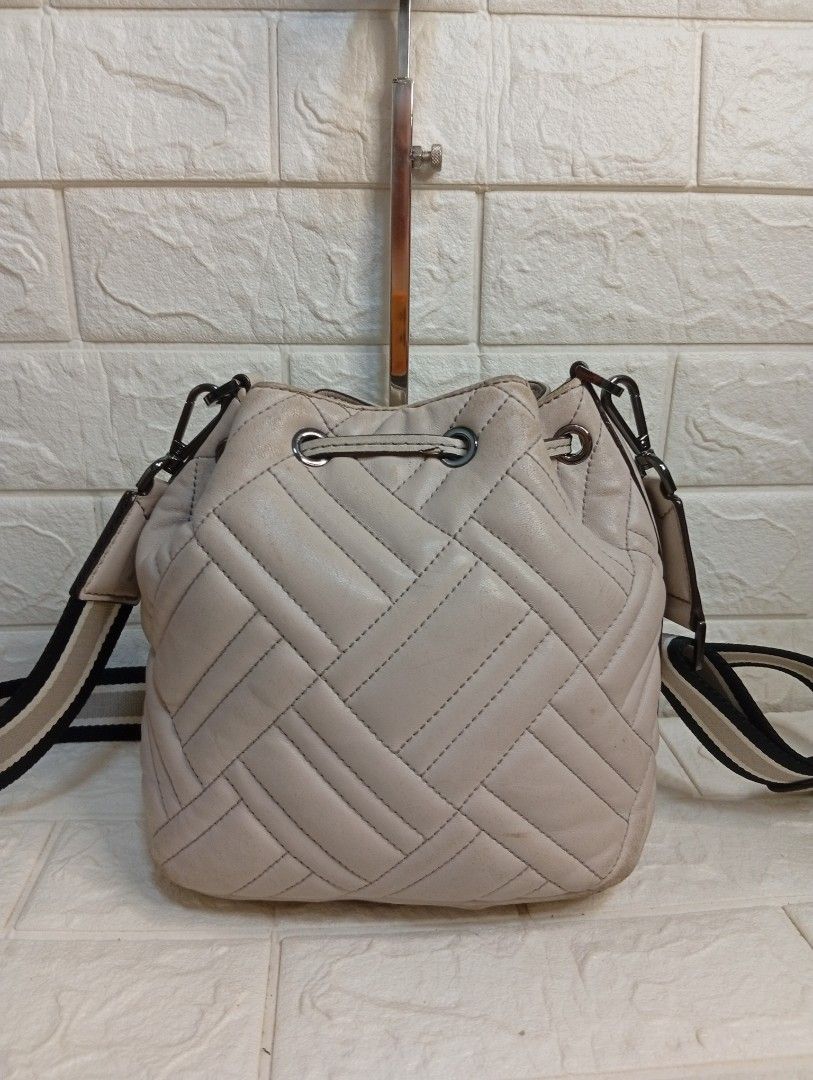 Michael Kors Quilted Leather Bucket Bag (Category: Cross-body Bags) located in Las Pinas. Submitted by etoksi1234 (Listing ID 1462184616, Image 2). Description: Pre-loved Michael Kors Extra Small Peyton Quilted Bucket Crossbody Bag, featured in a soft cement-grey leather with a sporty striped webbing strap..