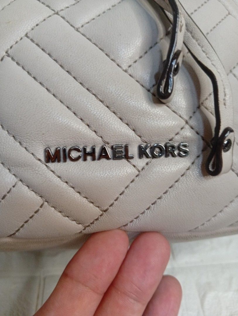 Michael Kors Quilted Leather Bucket Bag (Category: Cross-body Bags) located in Las Pinas. Submitted by etoksi1234 (Listing ID 1462184616, Image 3). Description: Pre-loved Michael Kors Extra Small Peyton Quilted Bucket Crossbody Bag, featured in a soft cement-grey leather with a sporty striped webbing strap..