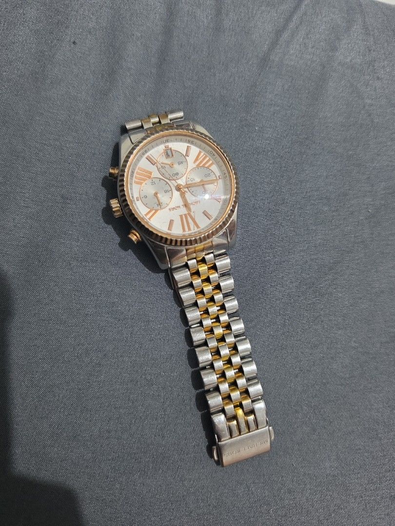 Michael Kors Watch (Category: Women's Watches) located in Manila. Submitted by katiriin (Listing ID 1462208252, Image 3). Description: Selling an authentic Michael Kors Lexington watch (MK5735). Unit only, no more box.Condition: Heavily used / Medyo luma na. Flaws: May mga gasgas at faded na po ang gold color sa ibang bahagi ng strap/links dahil sa madalas na paggamit (kita sa pic ang condition). Bawal po sa maarte, pero pwedeng-pwede pa ring pan
