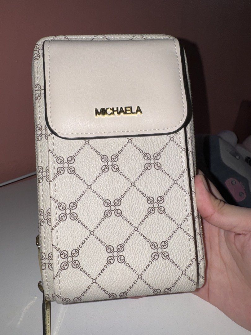 MICHAELA Phone Wallet Bag (Category: Wallets & Card holders) located in Marikina City. Submitted by iyashells (Listing ID 1462079205, Image 1). Description: - MICHAELA phone wallet - Cream color with all-over logo pattern - Multiple card slots inside - Zipper closure - Comes with a strap - Ideal for keeping essentials organized.