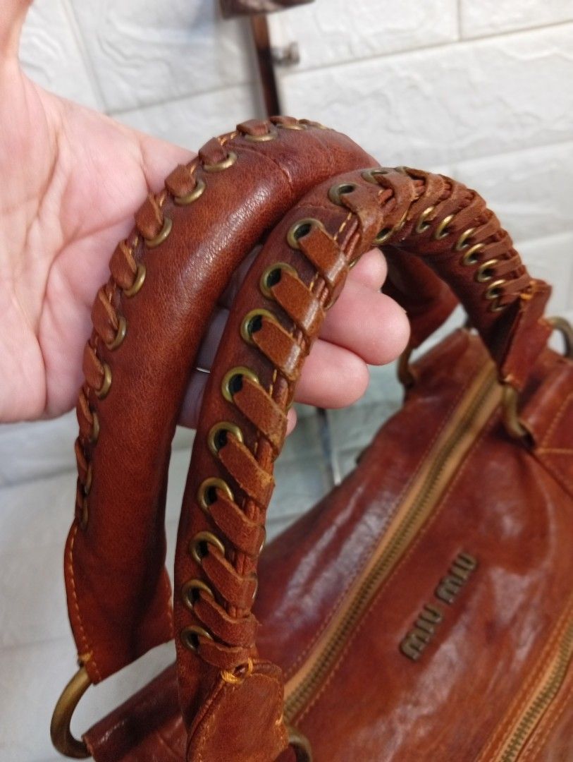 Miu Miu Brown Leather Gathered Shoulder Bag (Category: Shoulder Bags) located in Las Pinas. Submitted by etoksi1234 (Listing ID 1462123045, Image 3). Description: Pre-loved Miu Miu vintage brown leather satchel featuring a braided top handle and gathered front pocket detailing. NO WHTE TAG AND UNDERZIP.