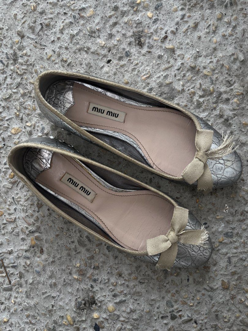 Miu Miu Metallic Crystal-Heel Ballet Flats (Category: Sneakers & Footwear) located in Dasmarinas. Submitted by bandananowheree (Listing ID 1462065415, Image 2). Description: Miu Miu Metallic Crystal-Heel Ballet Flats This vintage-inspired style combines a textured metallic silver or pale gold upper with a soft fabric bow at the round toe. The signature design feature is the chunky low block heel heavily encrusted with sparkling multi-sized facete