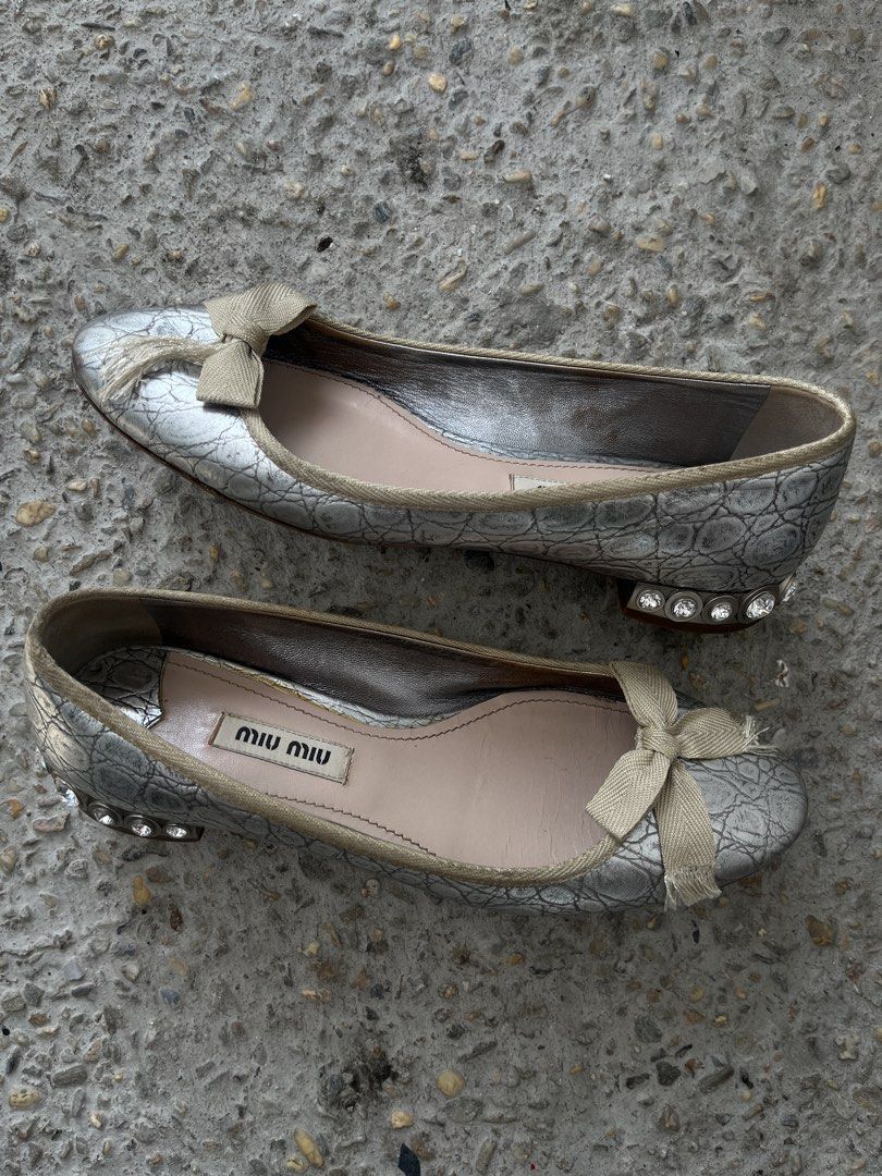 Miu Miu Metallic Crystal-Heel Ballet Flats (Category: Sneakers & Footwear) located in Dasmarinas. Submitted by bandananowheree (Listing ID 1462065415, Image 3). Description: Miu Miu Metallic Crystal-Heel Ballet Flats This vintage-inspired style combines a textured metallic silver or pale gold upper with a soft fabric bow at the round toe. The signature design feature is the chunky low block heel heavily encrusted with sparkling multi-sized facete