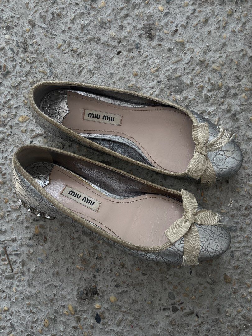 Miu Miu Metallic Crystal-Heel Ballet Flats (Category: Sneakers & Footwear) located in Dasmarinas. Submitted by bandananowheree (Listing ID 1462065415, Image 1). Description: Miu Miu Metallic Crystal-Heel Ballet Flats This vintage-inspired style combines a textured metallic silver or pale gold upper with a soft fabric bow at the round toe. The signature design feature is the chunky low block heel heavily encrusted with sparkling multi-sized facete
