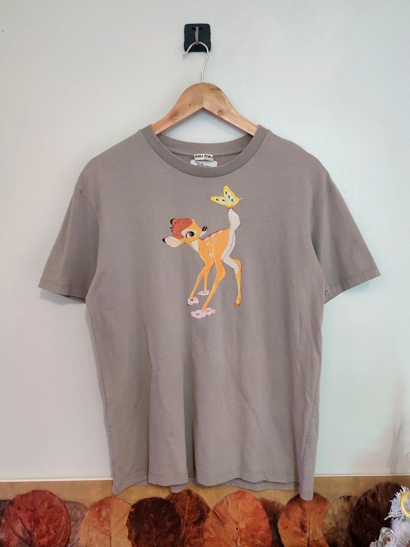 Miu Miu x Disney Bambi Tee (Category: Luxury Apparel) located in Ibajay. Submitted by trendholicrepublique (Listing ID 1462065612, Image 1). Description: Miu Miu x Disney Bambi Tee 399 Php Color Rate 9.8/10 Small On Tag (Fit to Medium) Dimes 20.5 x 26 Very Good to Excellent Condition (need wash) Issue: 1 tiny pinhole.