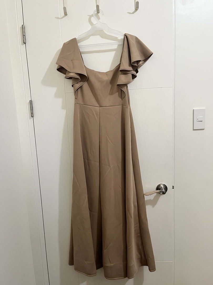 Mocha Butterfly Gown (Category: Dresses) located in Pasig City. Submitted by titathings (Listing ID 1462055138, Image 2). Description: - Used once - Sweetheart neckline with center bust ruching, ruffled sleeves, and a floor-length A-line skirt - Taupe / Mocha / Nude Brown - Fabric: Neoprene - No inclusions RFS: Decluttering Location: Pasig Mop: Gcash, GoTyme Mod: Lalamove, Grab, J&T (sf c/o buyer).