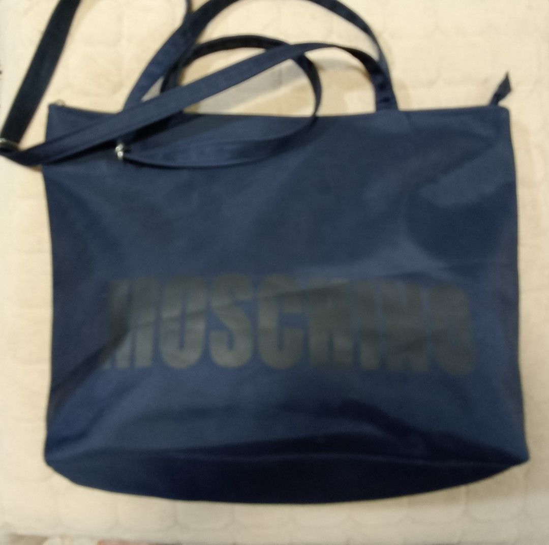 Moschino nylon bag (Category: Shoulder Bags) located in Caloocan City. Submitted by pvaliao (Listing ID 1462079320, Image 1). Description: Moschino nylon bag Brand: Moschino Price: 150 Color: Black Size: 17 inches × 12 inches Material: crafted from a durable , weather resistant nylon shell that offers a slouchy silhouette and easy cleaning. Pre-owned Design: features a classic black color with a subtle printed Moschino branding text graphic cente