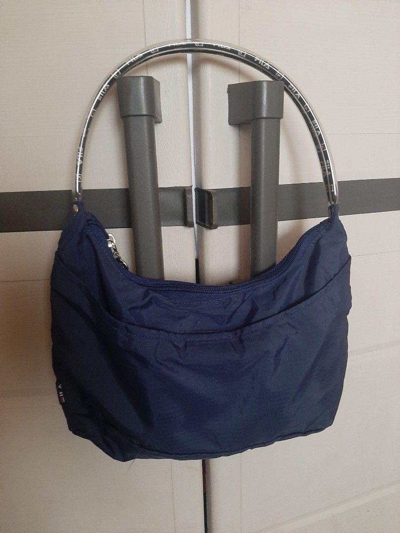 Navy Blue Fila Bag with Clear Strap (Category: Cross-body Bags) located in Bulacan. Submitted by edisoncert71953 (Listing ID 1462054034, Image 1). Description: - Navy blue bag - Clear strap with all-over Fila logo print - Zipper closure - Made of nylon or similar material - Ideal for carrying your essentials.