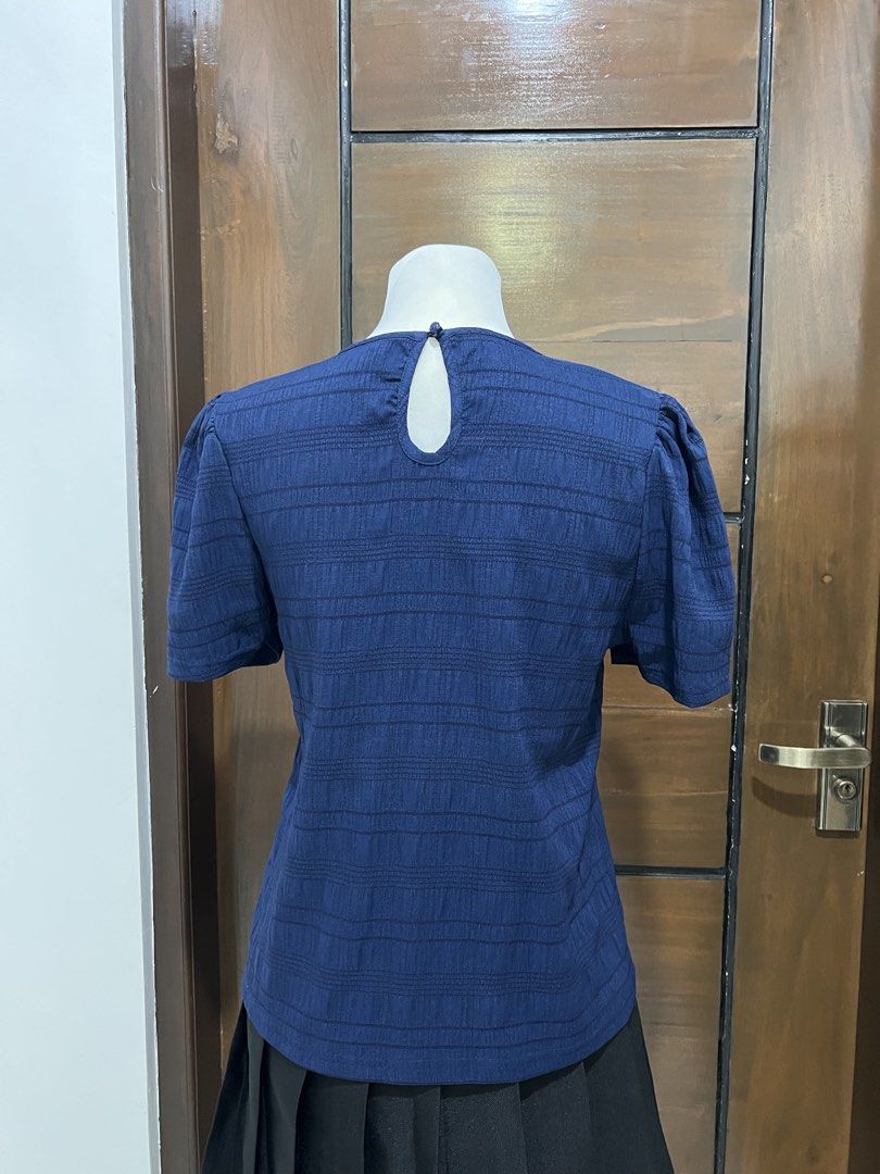 Navy Blue Puff Sleeve Top with Striped Texture (Category: Blouses) located in Angat. Submitted by yanacruise (Listing ID 1462051912, Image 3). Description: - Navy blue top - Textured horizontal stripe pattern - Short puff sleeves - Keyhole back closure with button - Versatile for casual or semi-formal occasions - Comfortable and stylish.