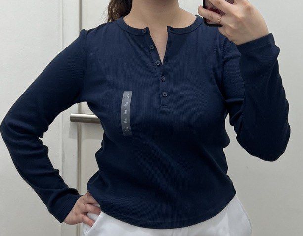 Navy Blue Ribbed Henley Long Sleeve Top (Category: Longsleeves) located in Valenzuela. Submitted by decluttering.manila (Listing ID 1462071911, Image 1). Description: - Navy blue ribbed long sleeve top - Henley style with button details at the neckline - Size L - Comfortable and versatile for everyday wear - Great for layering or wearing on its own - Easy to pair with jeans or skirts.