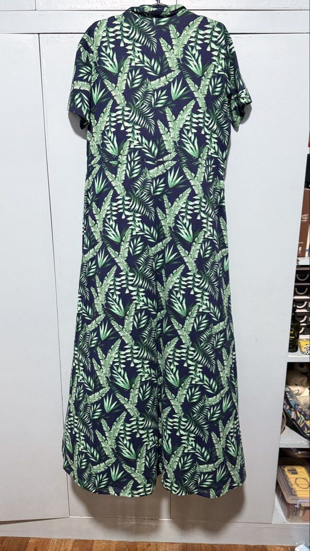 Navy Blue Tropical Leaf Print Button-Up Maxi Dress (Category: Dresses) located in Quezon City. Submitted by amogz (Listing ID 1462087557, Image 3). Description: - Navy blue maxi dress - Vibrant green tropical leaf print - Short sleeves - Collared neckline - Fake Button-up front with wooden-look buttons - Ideal for casual outings or beach vacations - Comfortable and stylish.