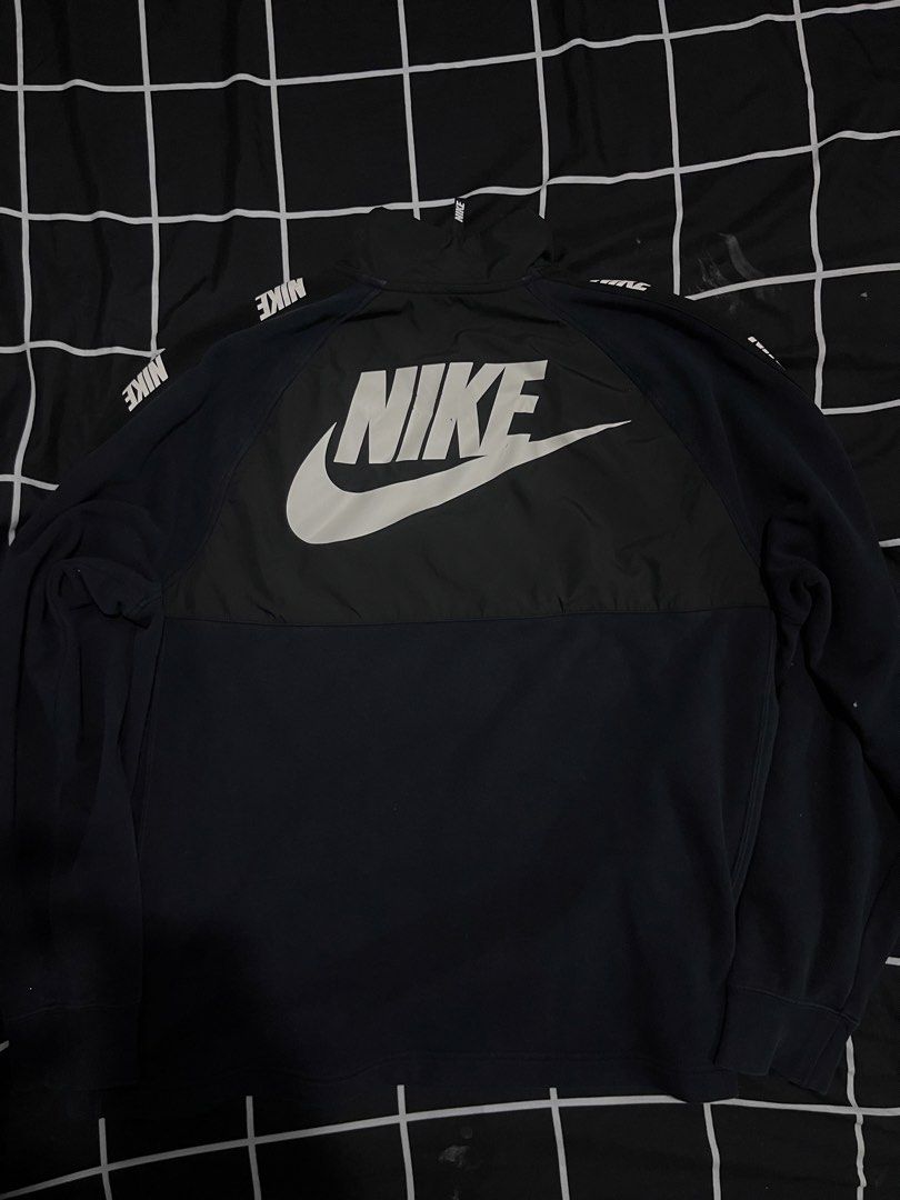 Nike Half Zip Pullover Sweatshirt Black Swoosh Logo (Category: Coats, Jackets and Outerwear) located in Manila. Submitted by aybancharlesss (Listing ID 1462182711, Image 2). Description: - Black Nike Pullover Sweatshirt - Size XL - Features a half-zip neckline - Nylon chest panel detail - Nike branding on chest and sleeves - Large Nike Swoosh logo on the back - Ideal for casual outings or workouts.