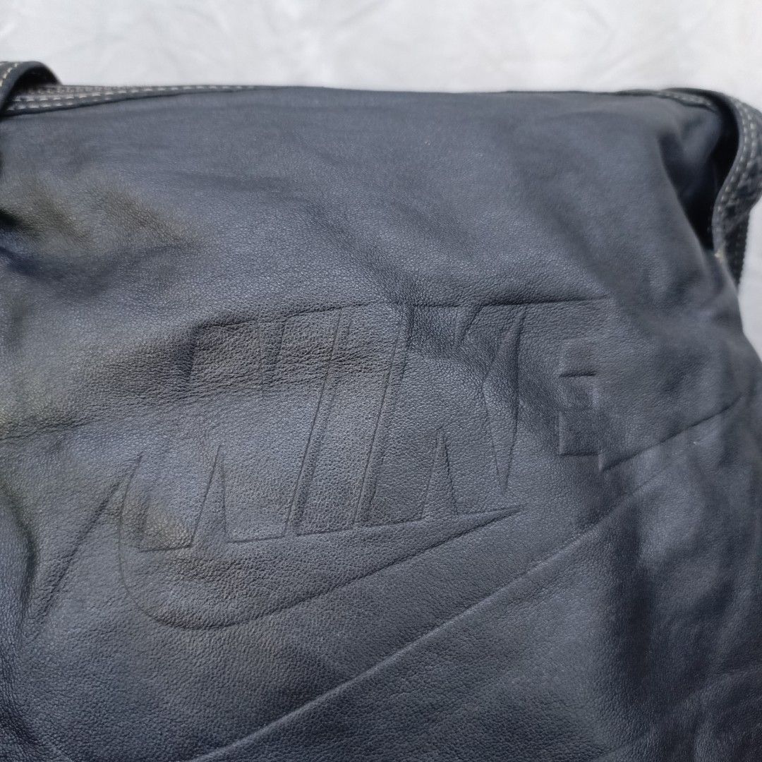 Nike Leather Shoulder Bag (Category: Shoulder Bags) located in Pasay City. Submitted by joanirishb86535 (Listing ID 1462121769, Image 1). Description: - Genuine black leather Nike shoulder bag - Features embossed Nike logo on the front - Stylish braided details on straps and sides - Secure zipper closure - Interior includes a zip pocket and a mesh pocket - Ideal for everyday use and carrying your essentials.