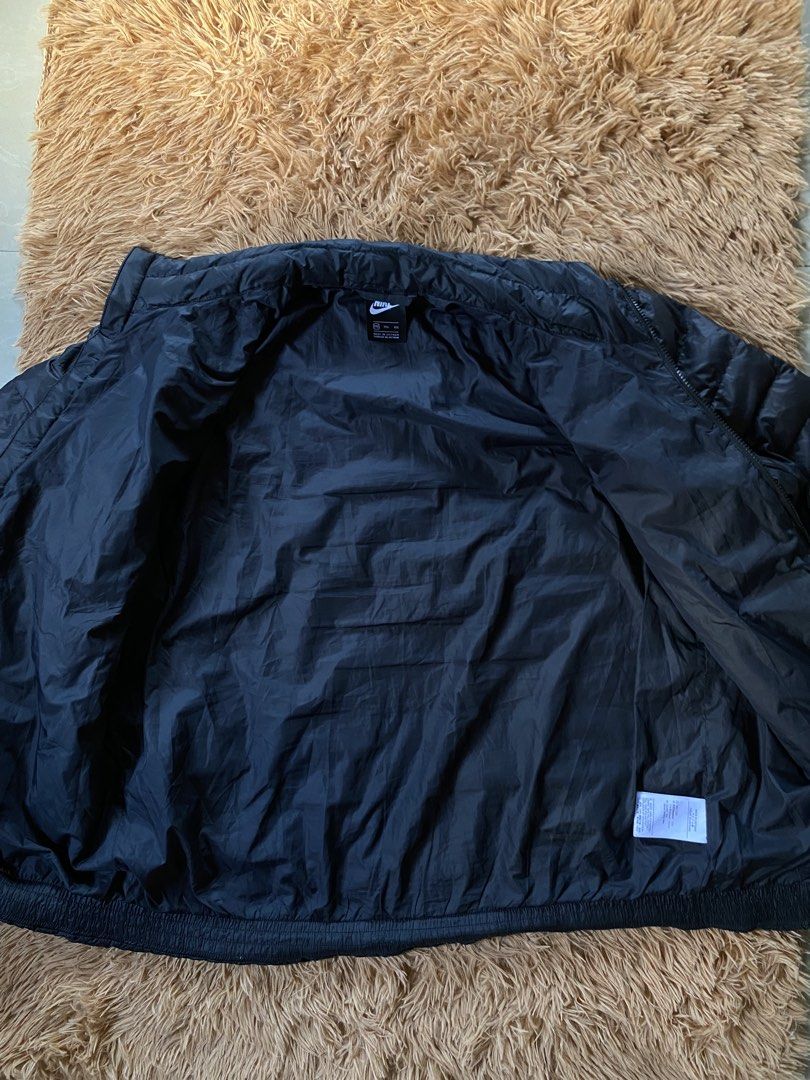 Nike puffer double zip (Category: Coats, Jackets and Outerwear) located in Marikina City. Submitted by andreioruga (Listing ID 1462204145, Image 2). Description: size: xxl W 24.5 | L 28.5 | SL 26.5 color rate: 10/10 issue: two pinhole and very unnoticeable ended stitch (see last 4pics) condition: excellent overall condition dm for more info 📩.