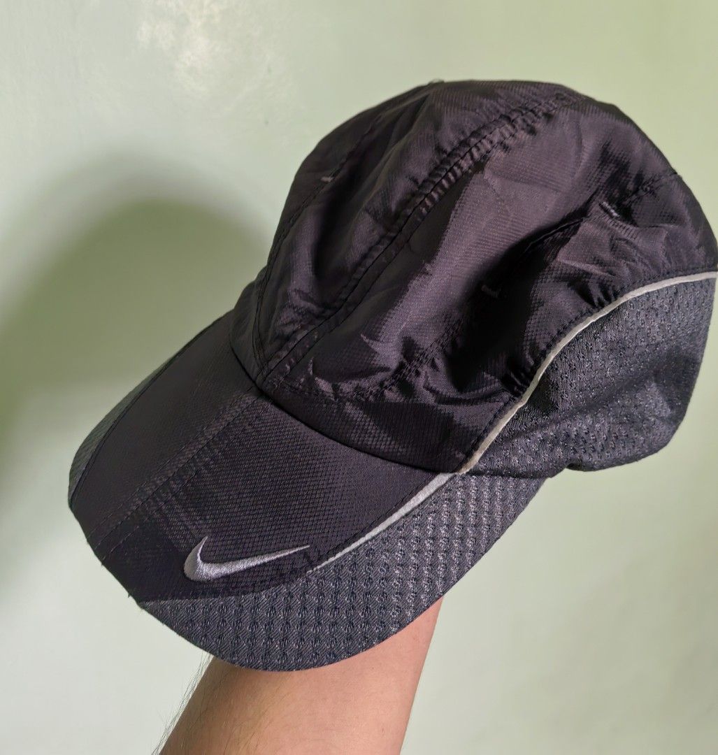 Nike Running Cap (Category: Caps & Hats) located in Quezon. Submitted by miksxthrift (Listing ID 1462062427, Image 1). Description: - Black Nike cap - Ideal for running and sports - Lightweight material - Reflective strip on brim - Breathable mesh side panels - Adjustable strap at the back - Features Nike logo on the front.