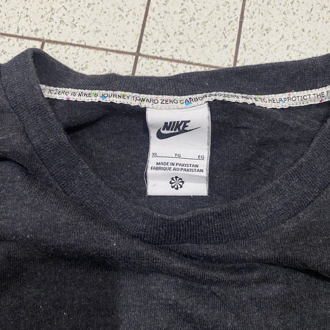 Nike T-Shirt XL Dark Grey (Category: Tshirts & Polo Shirts ) located in Manila. Submitted by sepamorash53558 (Listing ID 1462081298, Image 3). Description: - Dark grey Nike t-shirt - Size: XL - Material: Cotton blend with polyester (check label for details) - Design: Textured, glittery Nike logo on chest - Accent: Small 'USK x 27' tag - Origin: Made in Pakistan.