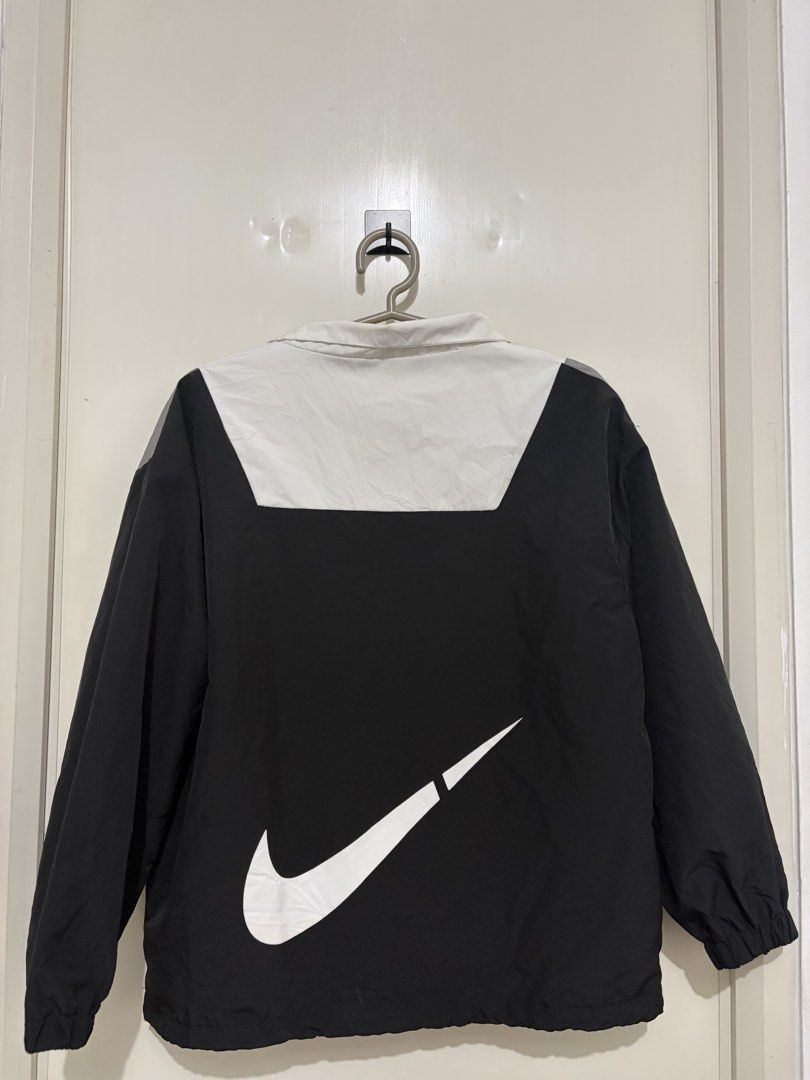 Nike Windbreaker Jacket Color Block Swoosh (Category: Coats, Jackets and Outerwear) located in Pasig City. Submitted by carissuh99 (Listing ID 1462124680, Image 2). Description: - Nike windbreaker jacket - Color block design: Grey, white, and black - Large white Nike swoosh on the back - Quarter zip neckline - Elastic cuffs and hem - Ideal for casual wear or sports activities.