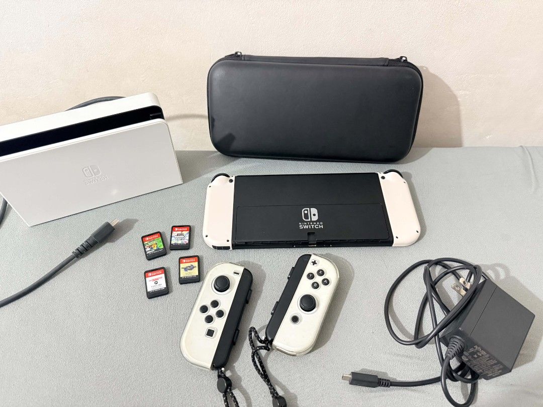 Nintendo Switch Oled Bundle + 4 Games + Extra Joy-Con + Case and Pouch (Category: Nintendo) located in Manila. Submitted by jusippp (Listing ID 1462162711, Image 2). Description: Selling my Nintendo Switch Oled with multiple accessories and games. Great for anyone looking for a ready-to-play Switch bundle. Inclusions: - Nintendo Switch Oled Console - Original Joy-Con Controllers - Extra Joy-Con - Tempered Glass Screen Protector - Protective Case 