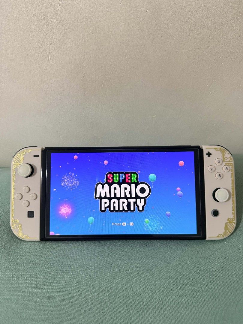 Nintendo Switch Oled Bundle + 4 Games + Extra Joy-Con + Case and Pouch (Category: Nintendo) located in Manila. Submitted by jusippp (Listing ID 1462162711, Image 3). Description: Selling my Nintendo Switch Oled with multiple accessories and games. Great for anyone looking for a ready-to-play Switch bundle. Inclusions: - Nintendo Switch Oled Console - Original Joy-Con Controllers - Extra Joy-Con - Tempered Glass Screen Protector - Protective Case 