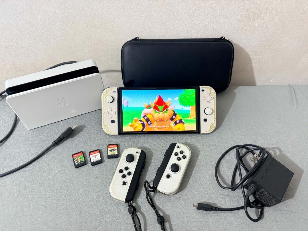 Nintendo Switch Oled Bundle + 4 Games + Extra Joy-Con + Case and Pouch (Category: Nintendo) located in Manila. Submitted by jusippp (Listing ID 1462162711, Image 1). Description: Selling my Nintendo Switch Oled with multiple accessories and games. Great for anyone looking for a ready-to-play Switch bundle. Inclusions: - Nintendo Switch Oled Console - Original Joy-Con Controllers - Extra Joy-Con - Tempered Glass Screen Protector - Protective Case 