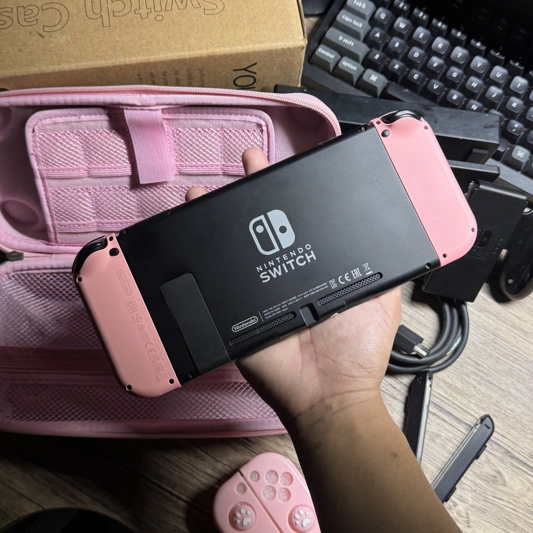 Nintendo Switch V2 complete Sakura Pink Set (Category: Nintendo) located in Quezon City. Submitted by consoleciety (Listing ID 1462222774, Image 3). Description: Selling Nintendo Switch V2 complete for ₱10,499 Sakura Pink setup 🥹 —presentable, 9.6/10 cosmetics condition | tempered glass installed —no issue, everything working & checked according to my guide (posted on black app) —original pastel pink joycons worth ~4K —complete accessories (no b
