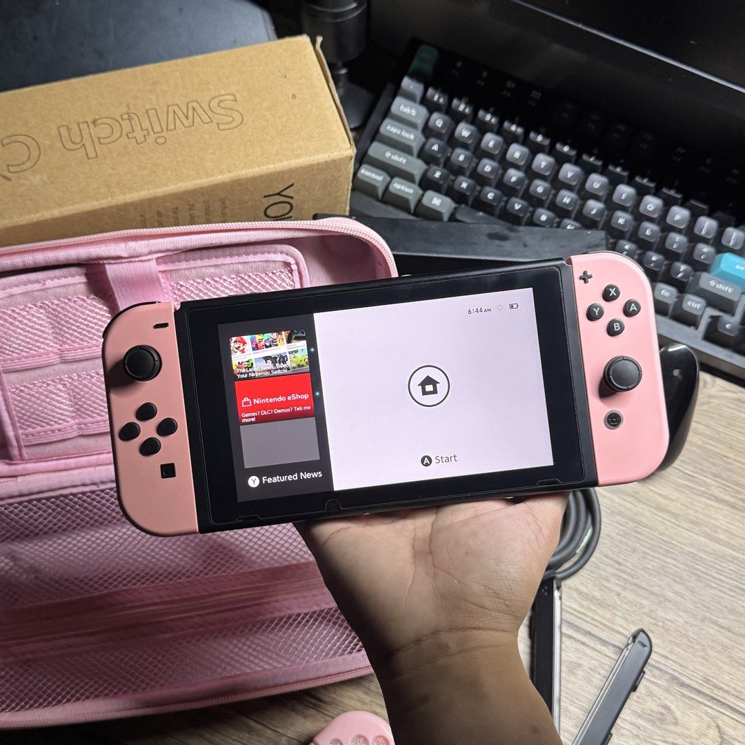 Nintendo Switch V2 complete Sakura Pink Set (Category: Nintendo) located in Quezon City. Submitted by consoleciety (Listing ID 1462222774, Image 2). Description: Selling Nintendo Switch V2 complete for ₱10,499 Sakura Pink setup 🥹 —presentable, 9.6/10 cosmetics condition | tempered glass installed —no issue, everything working & checked according to my guide (posted on black app) —original pastel pink joycons worth ~4K —complete accessories (no b