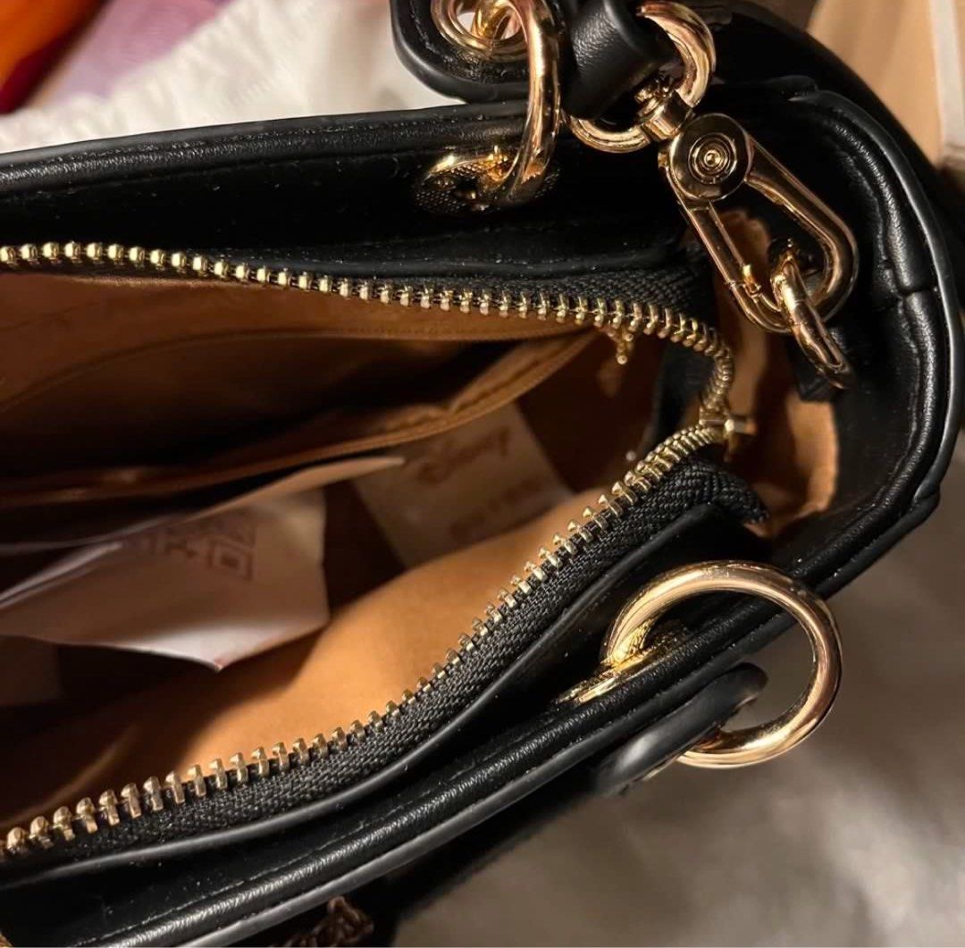 (NO ISSUE, AUTHENTIC) Black Mickey Mouse Quilted sling/hand bag (Category: Shoulder Bags) located in Manila. Submitted by solvithrifts (Listing ID 1462205586, Image 3). Description: - Cute black top handle bag - Features adorable Mickey Mouse quilting - Elegant gold hardware - Versatile chain strap - Comes with a charming Mickey Mouse accessory - Interior zip pocket for essentials - Disney branded dust bag included - Ideal gift for any Disney ent