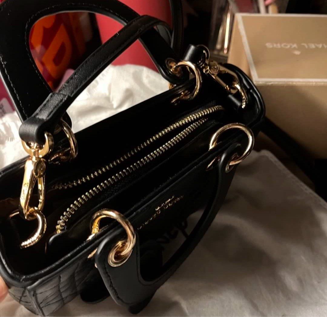 (NO ISSUE, AUTHENTIC) Black Mickey Mouse Quilted sling/hand bag (Category: Shoulder Bags) located in Manila. Submitted by solvithrifts (Listing ID 1462205586, Image 2). Description: - Cute black top handle bag - Features adorable Mickey Mouse quilting - Elegant gold hardware - Versatile chain strap - Comes with a charming Mickey Mouse accessory - Interior zip pocket for essentials - Disney branded dust bag included - Ideal gift for any Disney ent