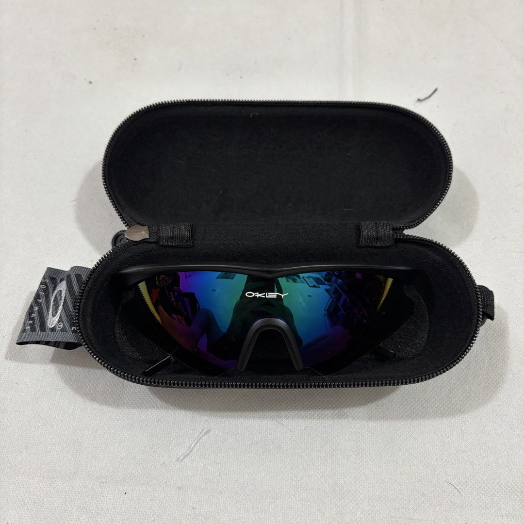 Oakley Sunglasses with Case (Category: Sunglasses & Eyewear) located in Cavite. Submitted by itsayaaa (Listing ID 1462093249, Image 2). Description: - Oakley sunglasses - Black frame with vibrant multi-colored lenses - Model number: 009101 - Comes with a protective hard case - Ideal for sports activities or everyday wear - Ready for a new owner!.