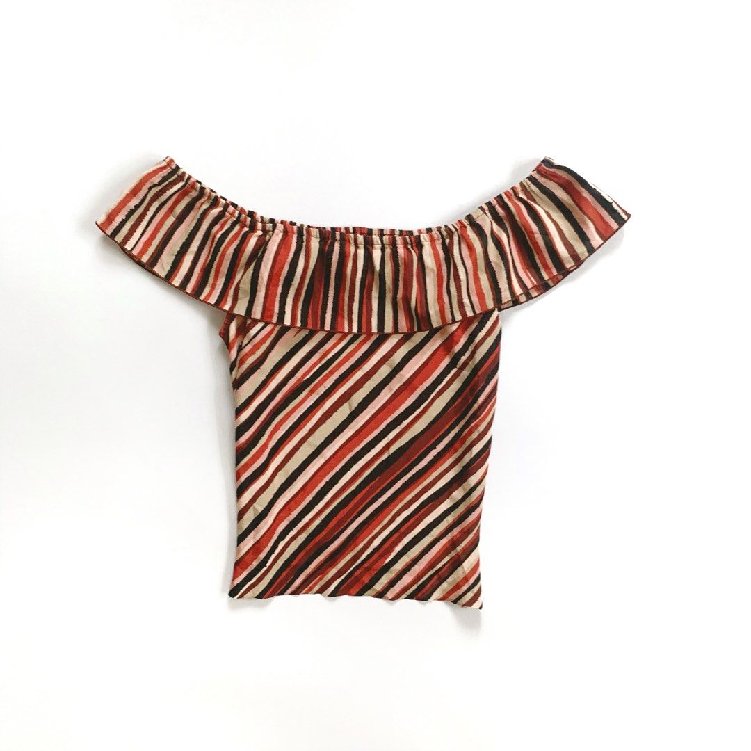 Off Shoulder Striped Ruffle Top (Category: Blouses) located in Tarlac. Submitted by luv__vintage (Listing ID 1462259597, Image 2). Description: - Cute off-shoulder design - Ruffle detail for added flair - Bold striped pattern (red, black, beige) - Fabric with a slight sheen - Versatile: pairs well with skirts or high-waisted pants - Ideal for night outs or casual wear.