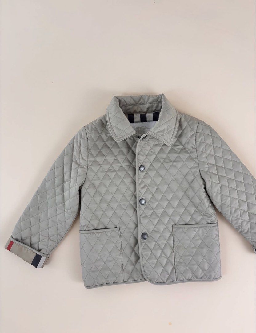 Original Burberry Childrens Quilted Jacket (Category: Babies & Kids Fashion) located in Cavite. Submitted by trendytop (Listing ID 1462043296, Image 1). Description: - Light grey quilted jacket for kids - Classic Burberry check lining - Button front closure - Two functional pockets - Signature Burberry stripe detail on cuffs - Ideal for cooler weather -Unisex -Bought 10k + in store.