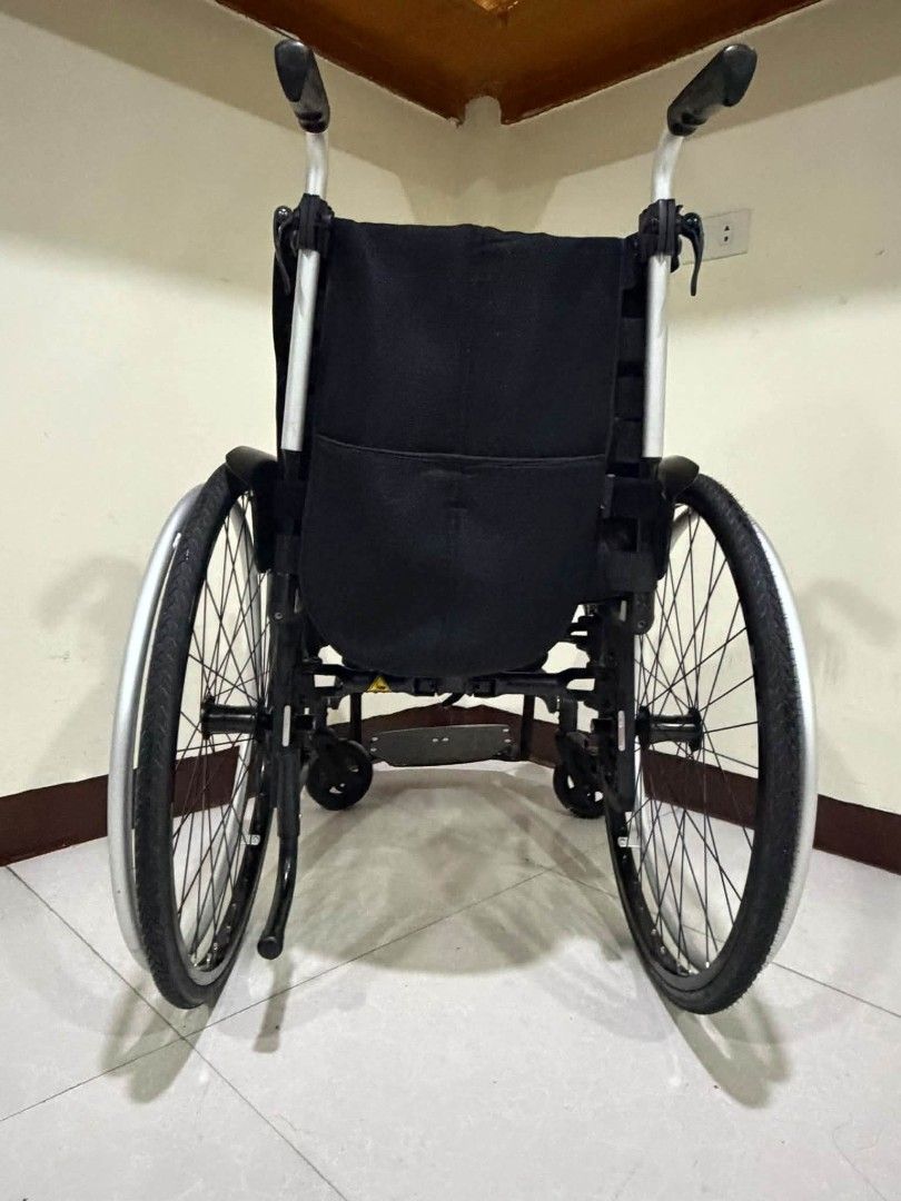 Ottobock Lightweight Folding Wheelchair (Category: Wheelchairs) located in Manila. Submitted by bravestorm.7b3e5f (Listing ID 1462110084, Image 2). Description: - Lightweight and folding Ottobock wheelchair - Easy to transport and store - Comfortable black fabric seat - Large rear wheels for smooth mobility - Smaller front casters for maneuverability - Includes a safety seatbelt - Ideal for mobility assistance.