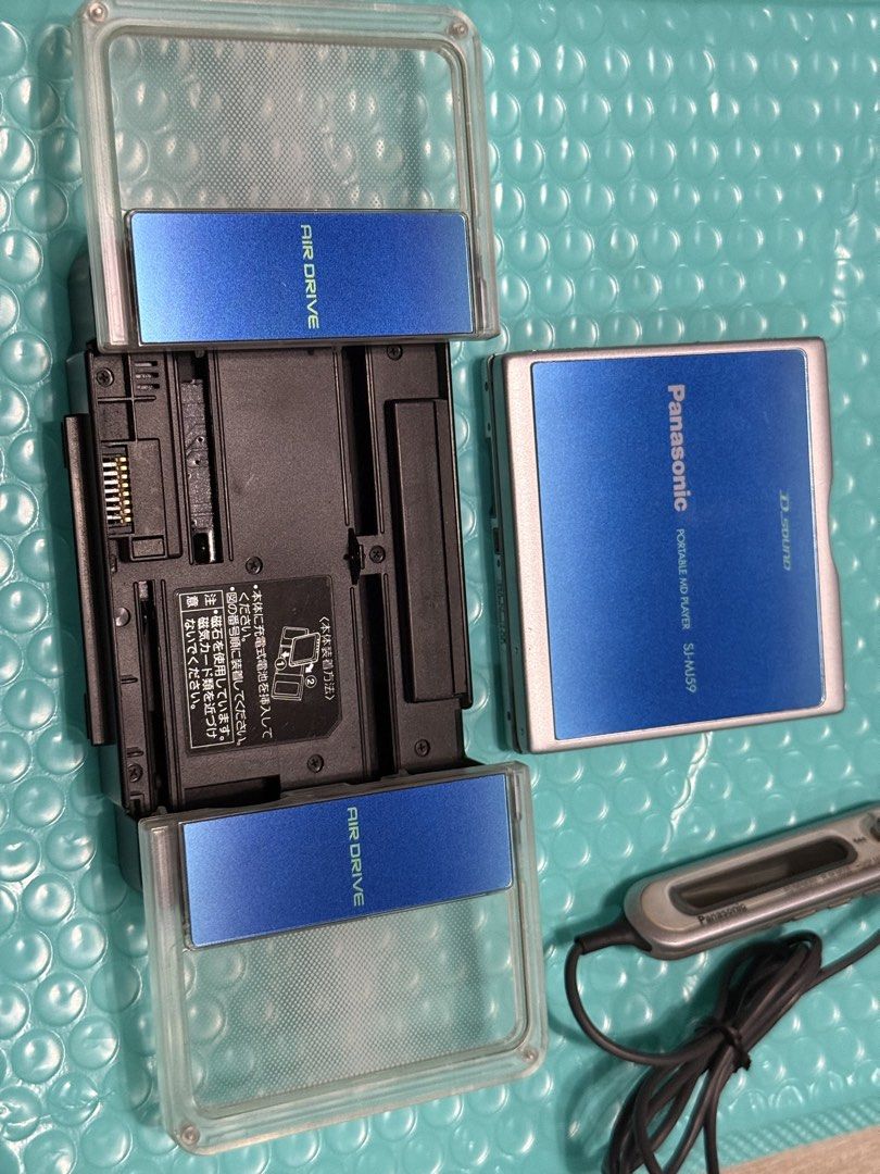 Panasonic Minidisc Player SJ-MJ59 with Speaker (Category: Portable Music Players) located in Makati City. Submitted by see5o5 (Listing ID 1462049854, Image 3). Description: - Panasonic MD portable MiniDisc player SJ-MJ59 - Tested and working (needs a new battery) - Includes: Air Drive speaker/charging dock, AC Adapter (100v), remote control - Also comes with one MiniDisc and the original Panasonic battery that needs to be replaced. This is over 2