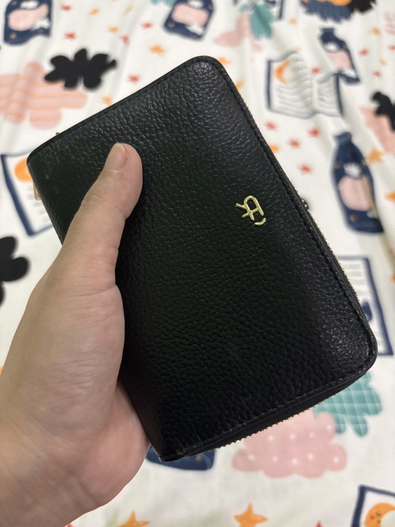 Parfois Black Leather Zip Around Wallet (Category: Wallets & Card holders) located in Rizal. Submitted by youronlineshoppe (Listing ID 1462181075, Image 1). Description: - Sleek black leather wallet - Secure zip-around closure - Multiple card slots for organization - Clear ID window for easy access - Convenient zippered coin pocket - Stylish textured exterior - Elegant small gold logo accent - Compact and practical for everyday use.