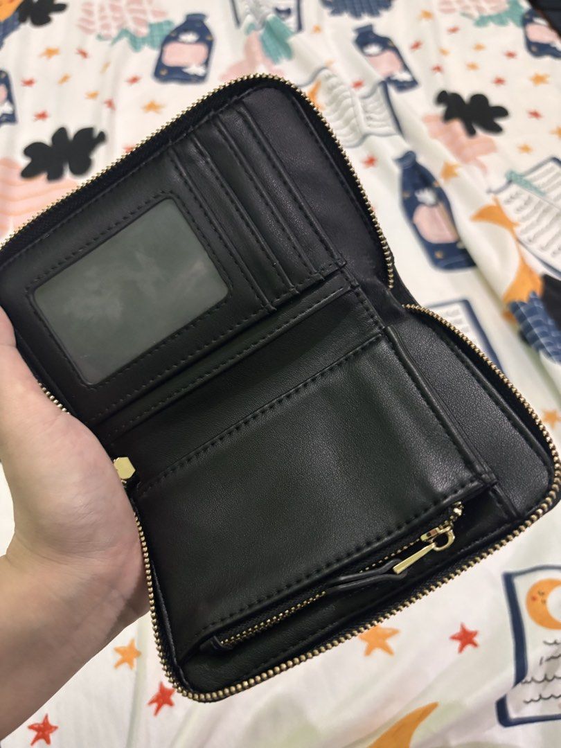 Parfois Black Leather Zip Around Wallet (Category: Wallets & Card holders) located in Rizal. Submitted by youronlineshoppe (Listing ID 1462181075, Image 3). Description: - Sleek black leather wallet - Secure zip-around closure - Multiple card slots for organization - Clear ID window for easy access - Convenient zippered coin pocket - Stylish textured exterior - Elegant small gold logo accent - Compact and practical for everyday use.