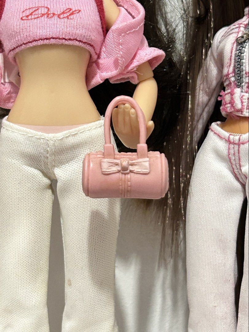 Pink Barrel Handbag Accessory for Dolls (Category: Purses & Pouches) located in Batangas. Submitted by nommi26 (Listing ID 1462199609, Image 2). Description: - Adorable pink barrel-shaped handbag. - Needs cleaning - Features a charming bow detail on the front. - Perfectly sized for fashion dolls. - A must-have accessory to complete any doll's look. - Adds a vibrant pop of color to outfits..