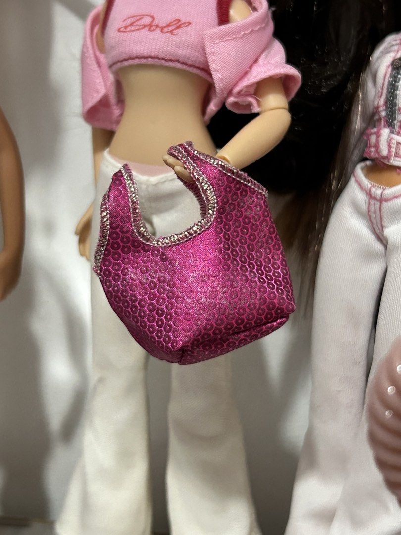 Pink Sequin Doll Handbag with Silver Trim (Category: Purses & Pouches) located in Batangas. Submitted by nommi26 (Listing ID 1462200977, Image 1). Description: - Adorable pink sequin handbag for dolls - Features sparkly silver trim on handles and opening - Unique honeycomb textured material - Perfect accessory to complete any doll's outfit - Ideal for imaginative dress-up play or display.