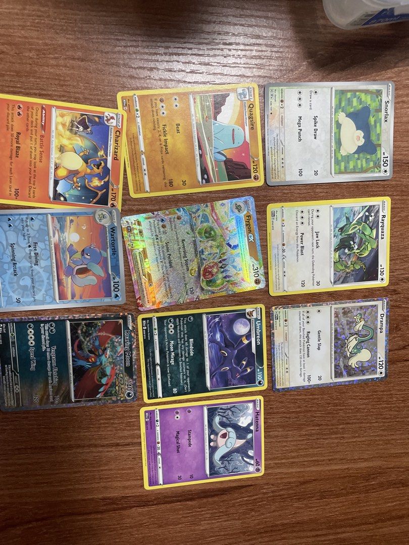POKÉMON TCG CARD BUNDLE + FREE Japanese Tretta Chips (Category: Raw Singles) located in Manila. Submitted by oscerino (Listing ID 1462102639, Image 1). Description: Selling my personal Pokémon card collection! 12 cards total, including a shiny Flygon ex (310 HP, holo), Roaring Moon ex, Charizard, Rayquaza, Umbreon, Snorlax, Drampa, and more. Great condition, stored properly, no bends/creases. 🎁 BONUS: Includes a set of rare Japanese Pokémon Tret