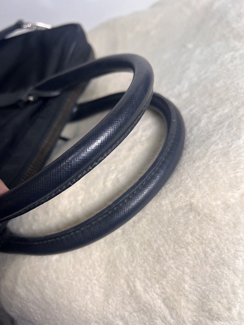 Prada Business/Laptop bag Guaranteed authentic (Category: Luxury Bags & Wallets) located in Makati City. Submitted by carullee (Listing ID 1462191307, Image 3). Description: Guaranteed authentic Japan sourced Prada laptop bag — UNISEX Nylon with leather trimming Can fit upto 14 inches laptop Minimal signs of use on corner No runs on nylon With cert of authenticity With detachable adjustable strap LAMPO UNDERZIP .