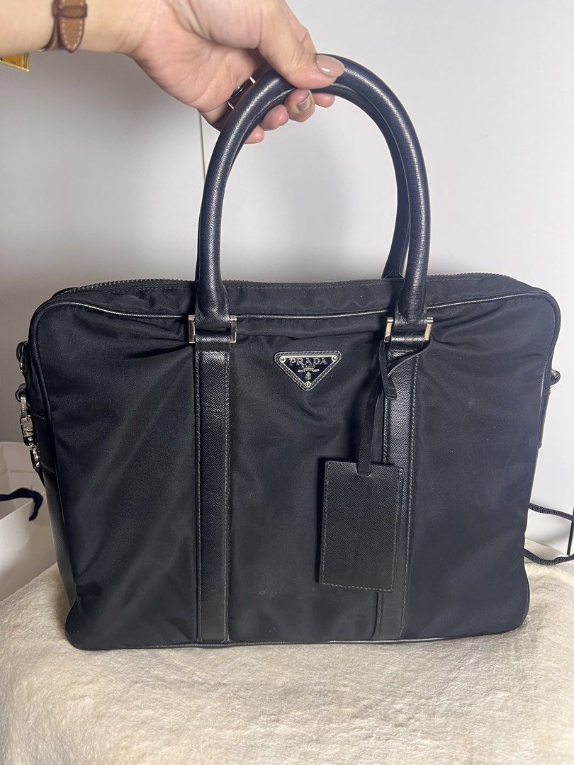 Prada Business/Laptop bag Guaranteed authentic (Category: Luxury Bags & Wallets) located in Makati City. Submitted by carullee (Listing ID 1462191307, Image 1). Description: Guaranteed authentic Japan sourced Prada laptop bag — UNISEX Nylon with leather trimming Can fit upto 14 inches laptop Minimal signs of use on corner No runs on nylon With cert of authenticity With detachable adjustable strap LAMPO UNDERZIP .