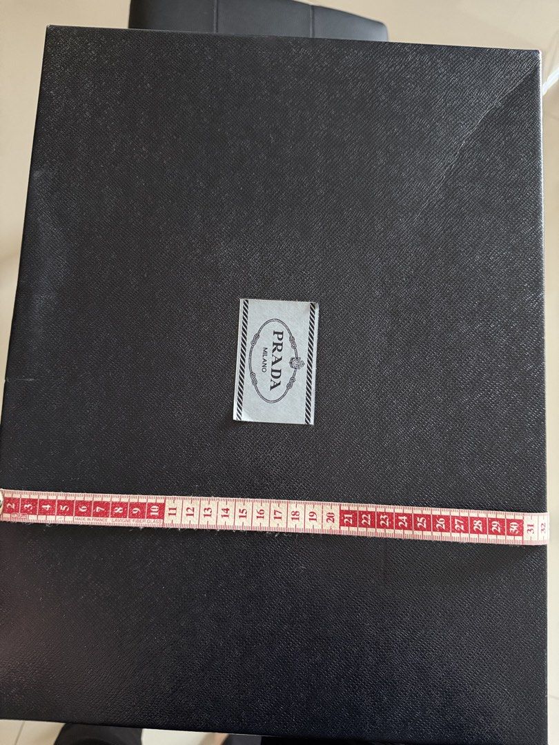 Prada Milano Black Box (Category: Luxury Bags & Wallets) located in Manila. Submitted by hotdealsph (Listing ID 1462109954, Image 3). Description: - Original Prada Milano box - Black textured exterior - Includes dust bag - Approximate dimensions: 42cm x 32cm x 15cm - Ideal for storing accessories or as a gift box.