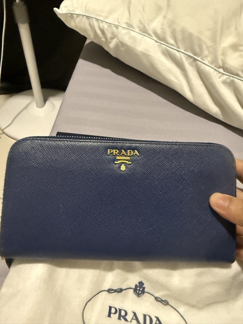 Prada Saffiano Leather Zip Around Wallet Navy Blue (Category: Luxury Bags & Wallets) located in Mandaluyong City. Submitted by huntervip (Listing ID 1462155234, Image 1). Description: - Authentic Prada wallet - Navy blue Saffiano leather - Gold hardware Prada logo - Includes original box, dust bag, and authenticity card - Secure zip-around closure - Plenty of space for cards and cash - Ideal for everyday use .