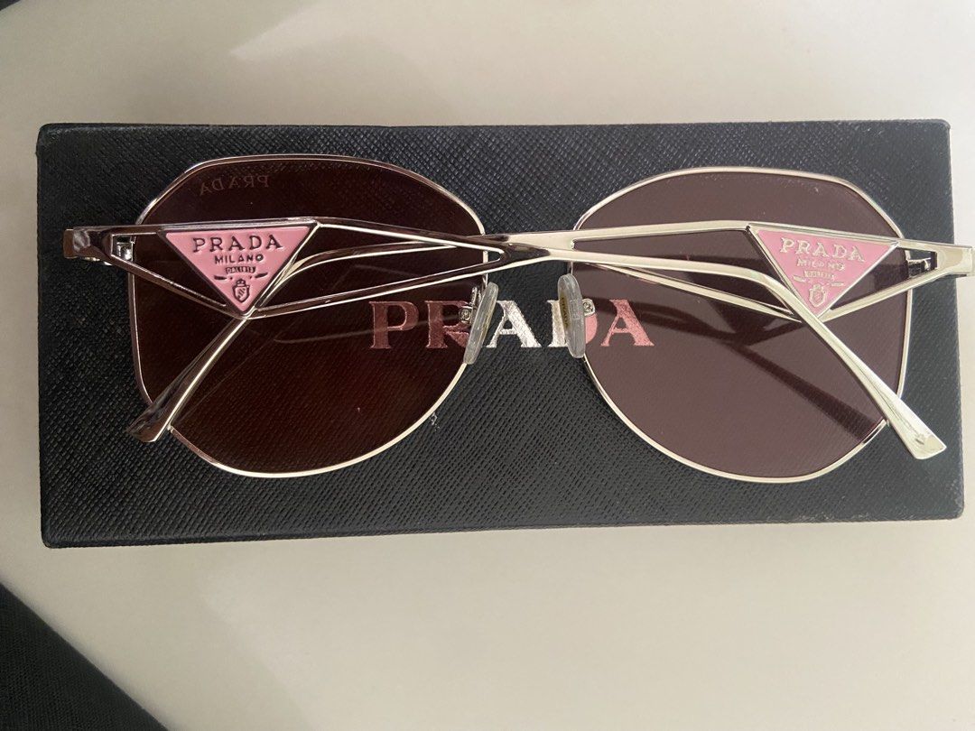 Prada Sunglasses Pink Oval Frame (Category: Sunglasses & Eyewear) located in Bangui. Submitted by loricam (Listing ID 1462054255, Image 1). Description: PRADA Milano Sunglasses ✨ • Like New / Never Used • Rose Gold Frame • Pink/Rose Tinted Lenses • Purchased in USA 🇺🇸 Selling because I wear prescription glasses and don’t get to use them. ❤️ Prada card/certificate was included when purchased but unfortunately got misplaced..